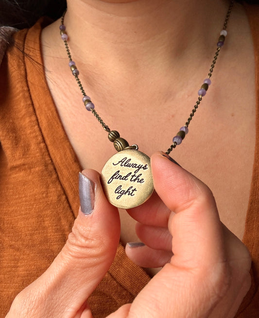 Antique gold color metal pendant with “always find the light” inscription