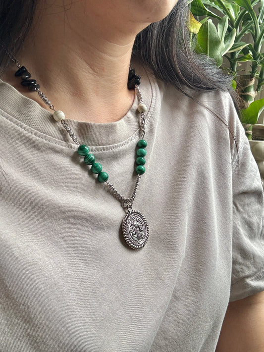 St. Benedict medallion necklace with beads, on model, side view.