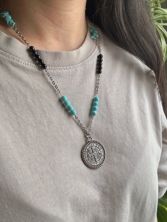 St. Benedict medallion necklace on model, side view