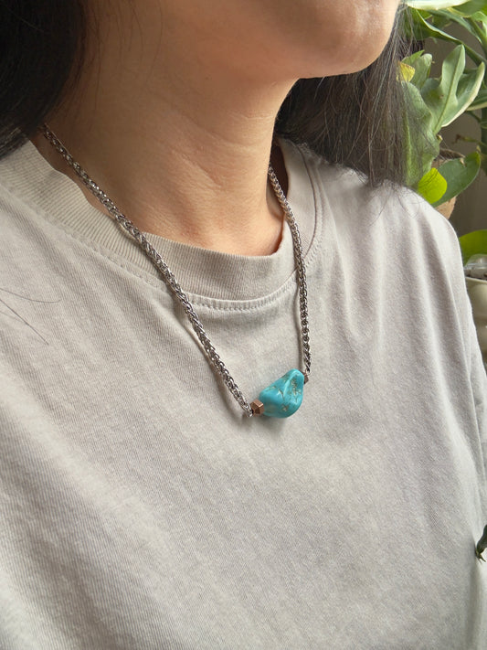 Blue howlite tumble necklace on model, side view