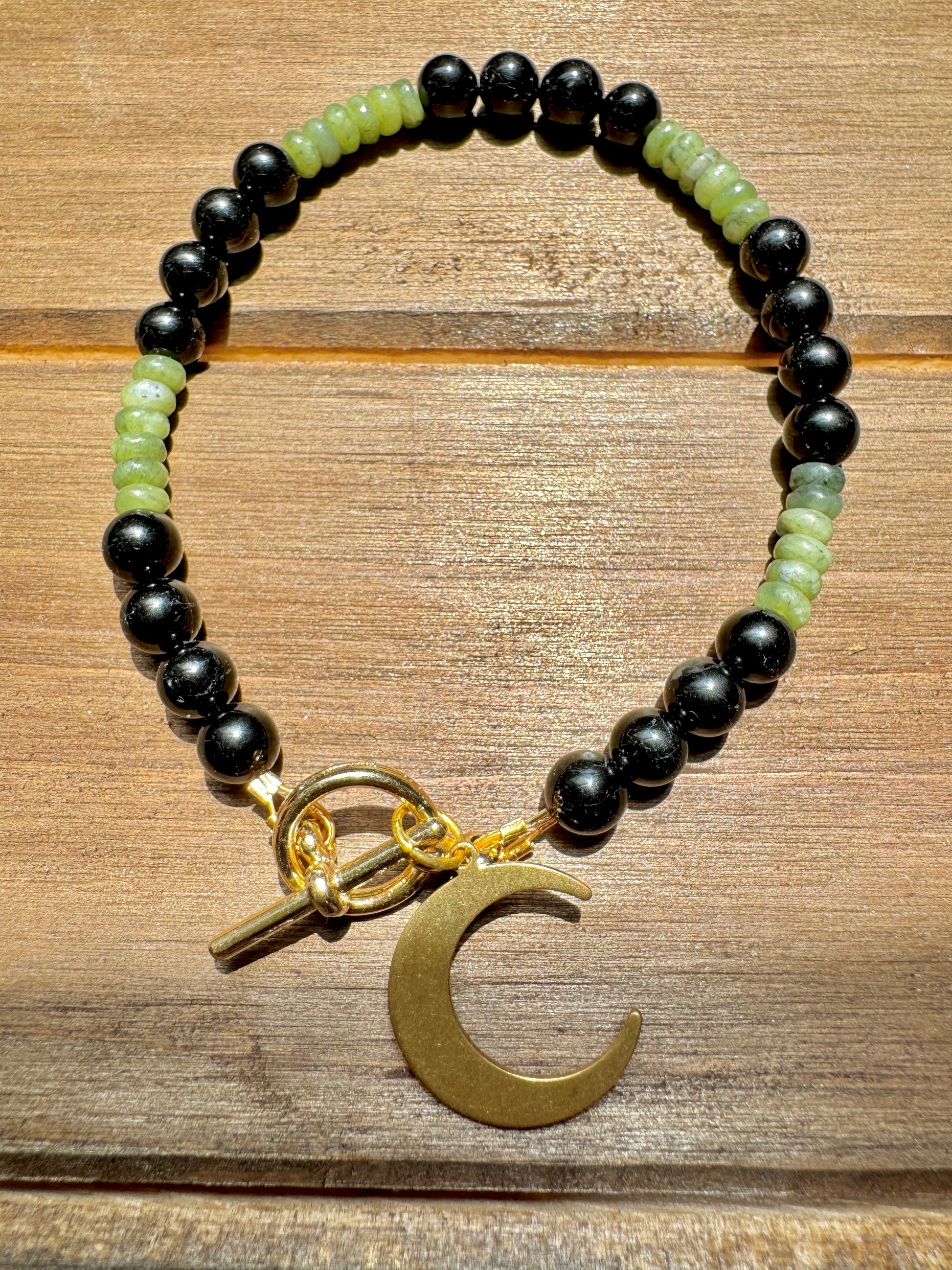 black tourmaline and olive jade beaded bracelet with gold moon charm