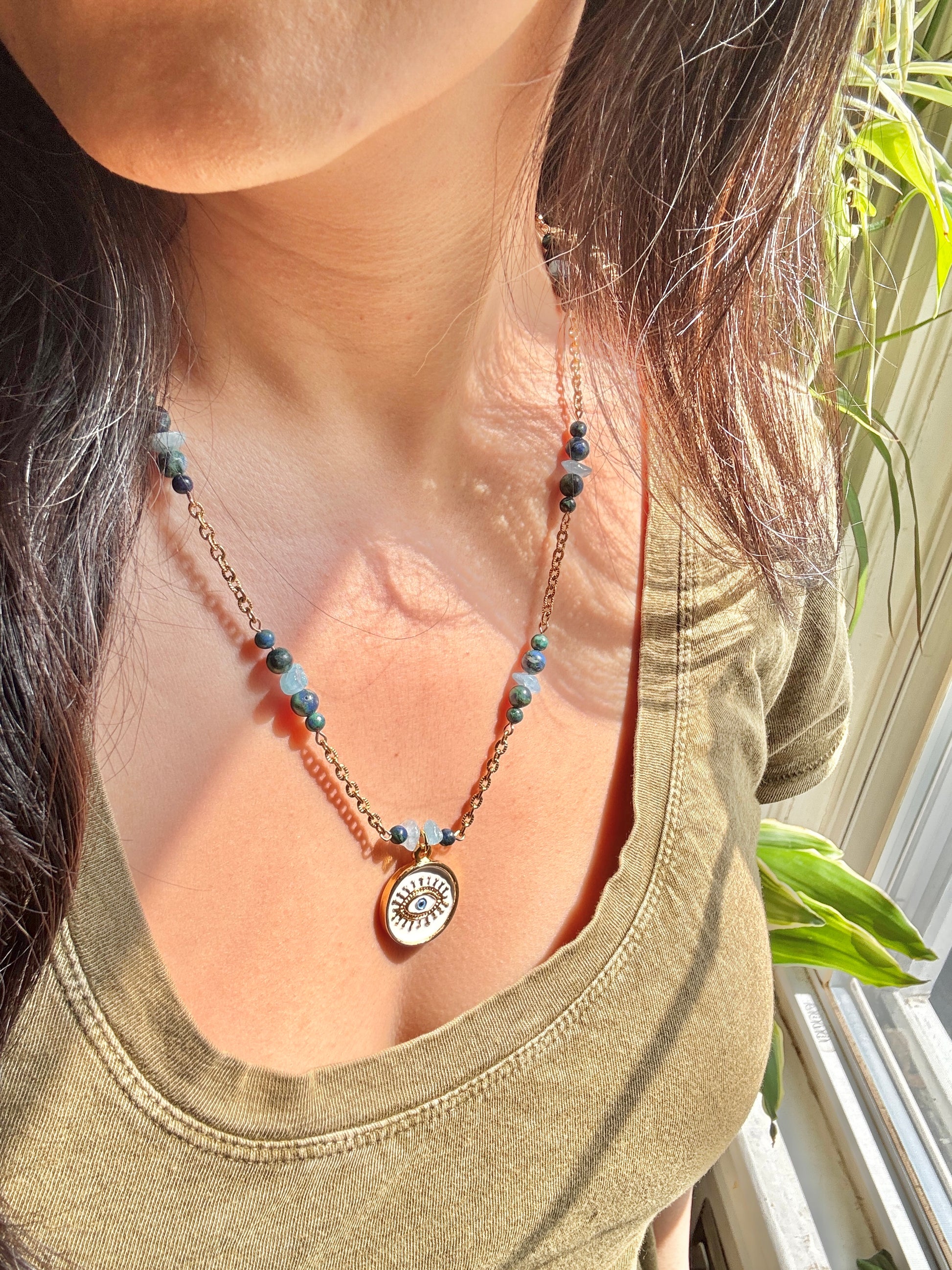 Eye pendant necklace worn by model
